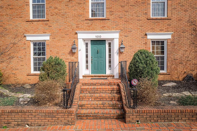 property entrance with brick siding