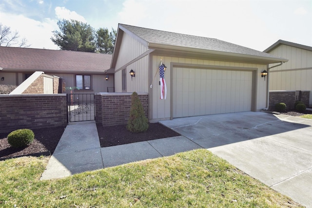 view of front of home with a garage, a fenced front yard, driveway, and a gate