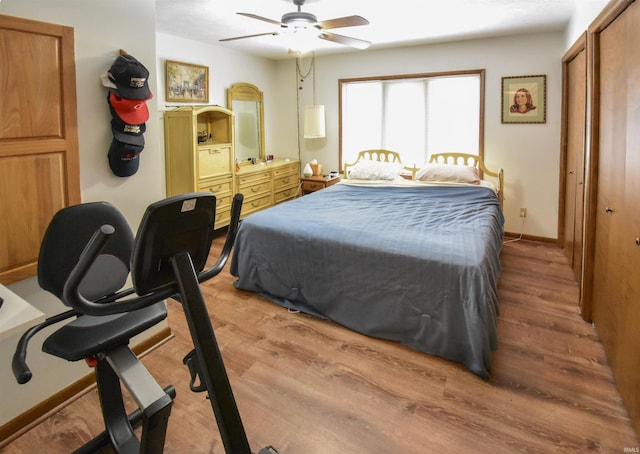 bedroom with baseboards, wood finished floors, and a ceiling fan