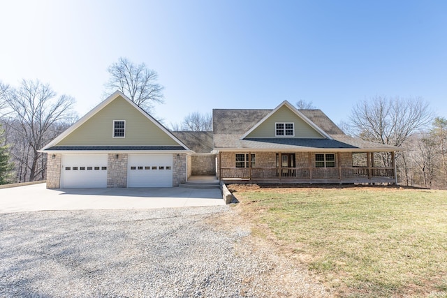 view of front of property featuring a front lawn, a garage, covered porch, and driveway