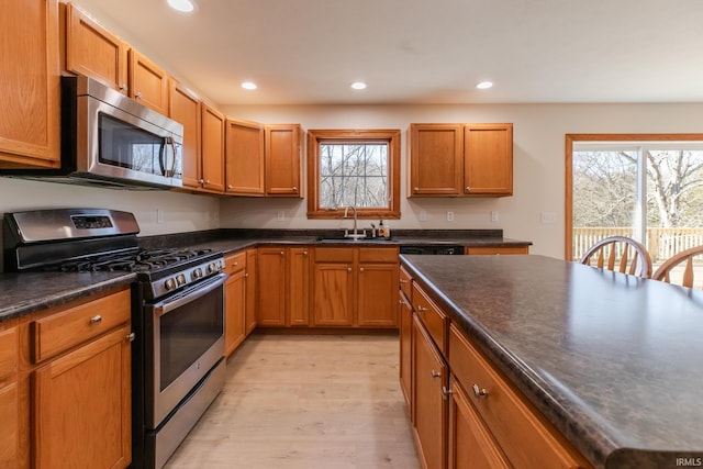 kitchen with plenty of natural light, recessed lighting, stainless steel appliances, and a sink