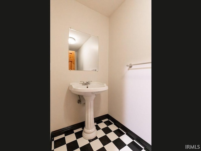 bathroom with tile patterned floors and baseboards