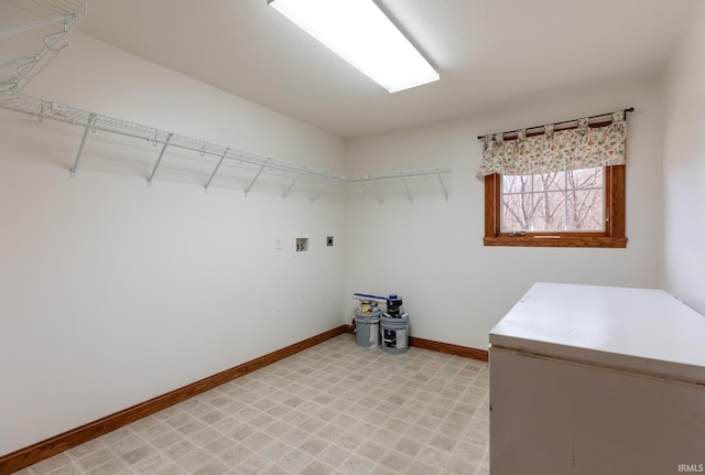 laundry room with baseboards, hookup for an electric dryer, light floors, and laundry area