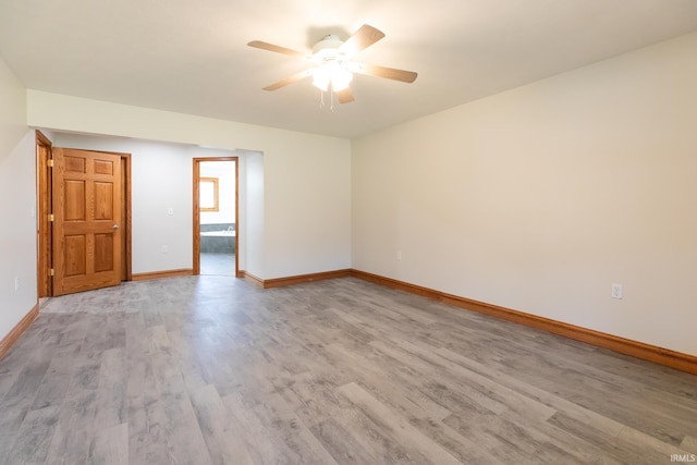 unfurnished room featuring light wood-style flooring, baseboards, and ceiling fan