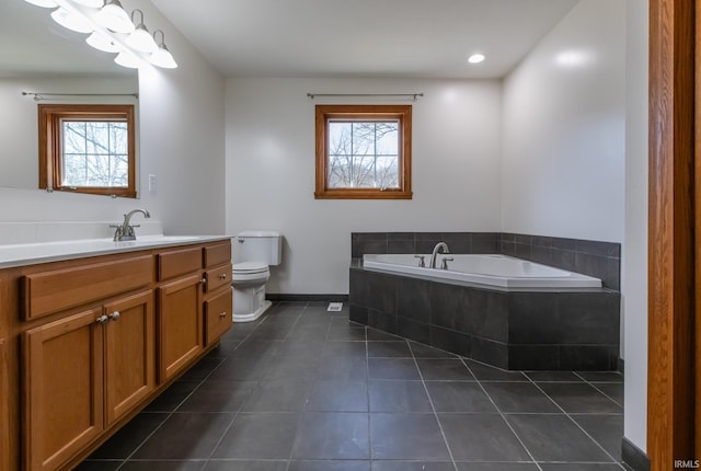 bathroom with tile patterned floors, plenty of natural light, toilet, and a bath