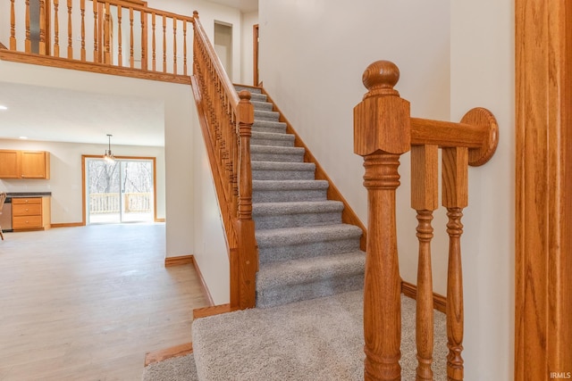 stairs with recessed lighting, wood finished floors, and baseboards