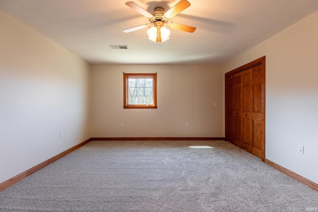 unfurnished bedroom featuring visible vents, light carpet, and baseboards