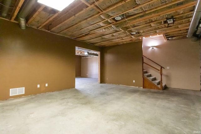 unfinished basement with visible vents and stairs