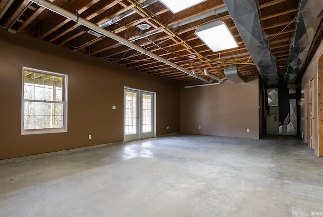 interior space featuring unfinished concrete flooring and french doors