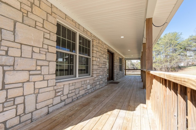 wooden terrace featuring covered porch