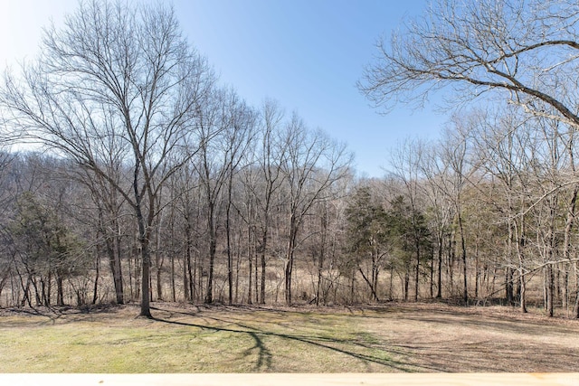 exterior space featuring a wooded view