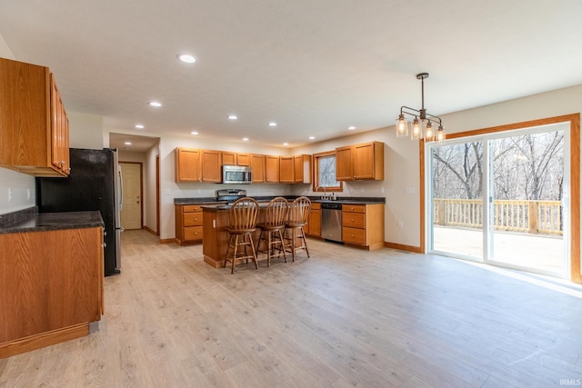 kitchen with dark countertops, appliances with stainless steel finishes, and a center island