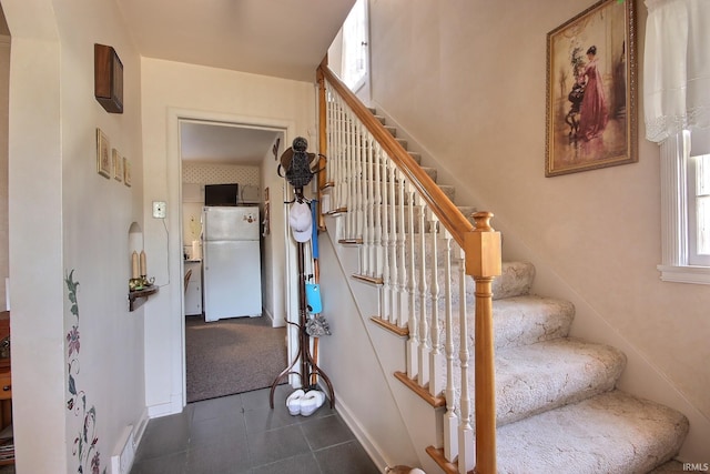 stairway with tile patterned flooring