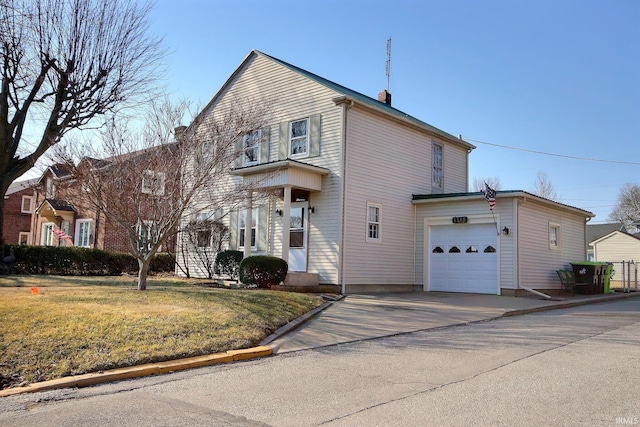 view of front of house featuring driveway, an attached garage, and a front yard