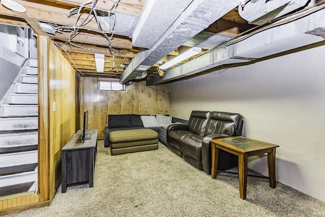 below grade area with stairway, carpet flooring, and wooden walls