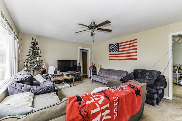 living room featuring carpet flooring and a ceiling fan