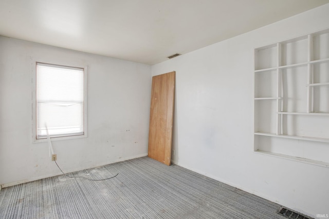 carpeted spare room with visible vents