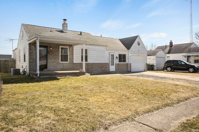 single story home featuring a front yard, an attached garage, and a shingled roof