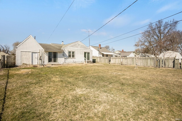 back of property with a yard, fence, and entry steps