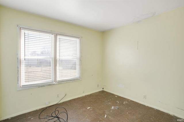 unfurnished room featuring baseboards