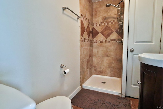 bathroom featuring vanity, toilet, and a stall shower