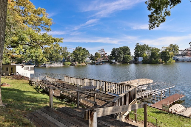 dock area with a yard and a water view