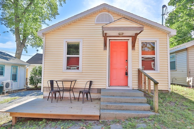 view of front of home with ac unit and a wooden deck