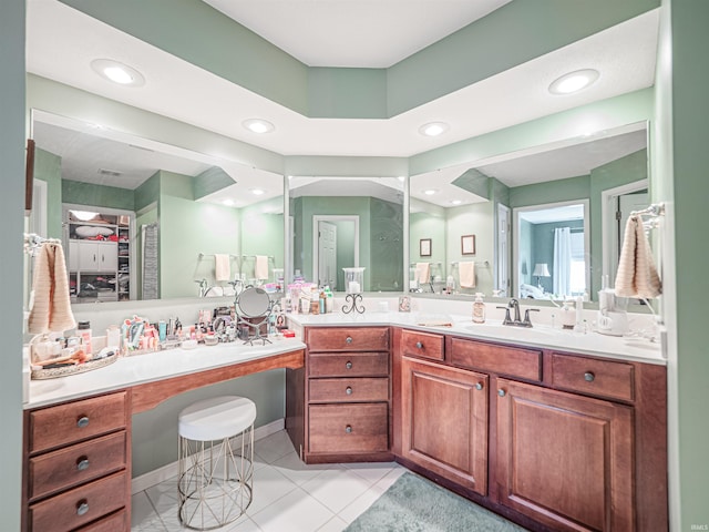 bathroom with vanity, a spacious closet, recessed lighting, and tile patterned flooring