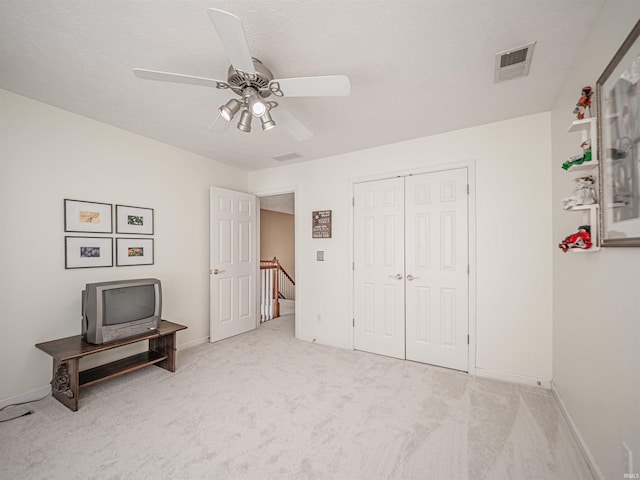 bedroom featuring baseboards, visible vents, a ceiling fan, and carpet