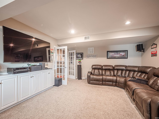 living area with recessed lighting, visible vents, light carpet, and french doors