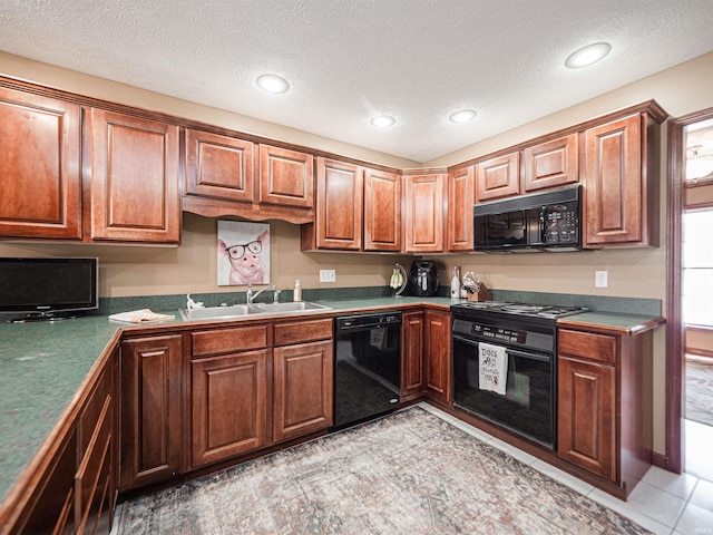 kitchen with light tile patterned floors, brown cabinetry, a sink, black appliances, and a textured ceiling