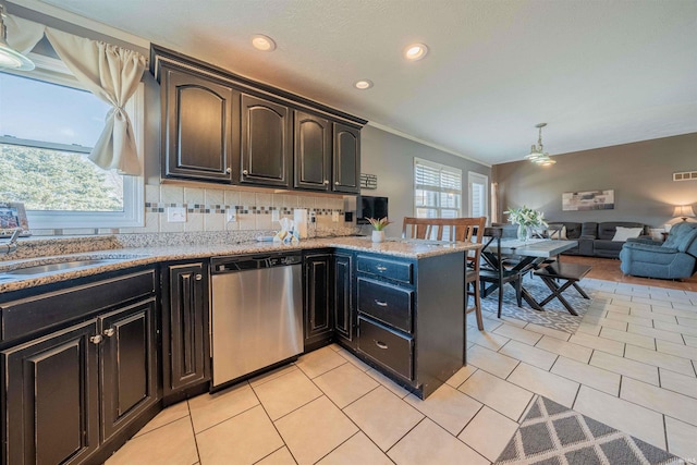 kitchen with light tile patterned flooring, backsplash, dishwasher, and a peninsula