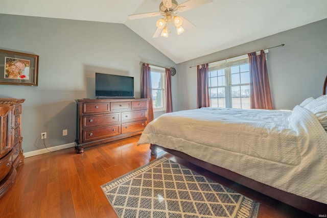 bedroom with ceiling fan, baseboards, lofted ceiling, and wood finished floors