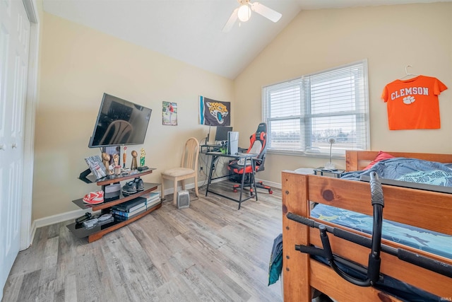 bedroom with ceiling fan, baseboards, wood finished floors, and vaulted ceiling