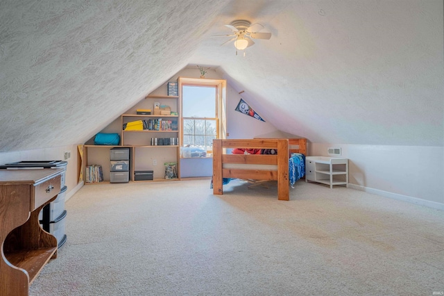 bedroom with lofted ceiling, baseboards, carpet floors, and a textured ceiling