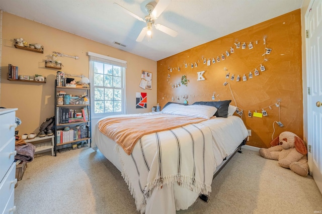 carpeted bedroom featuring visible vents and a ceiling fan