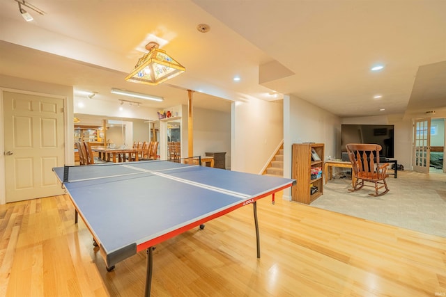 game room with recessed lighting and light wood-style floors