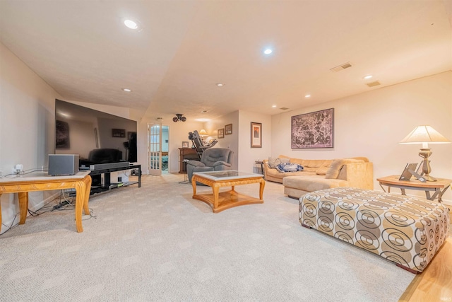 living area featuring visible vents, recessed lighting, and carpet flooring