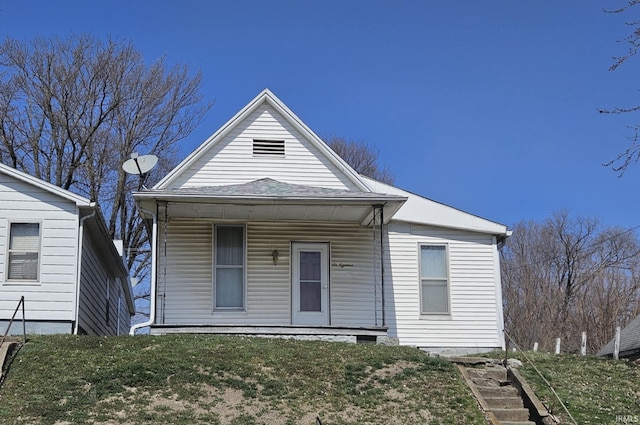 view of front of home featuring covered porch and a front lawn