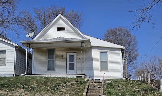 view of front of house with a porch and a front lawn