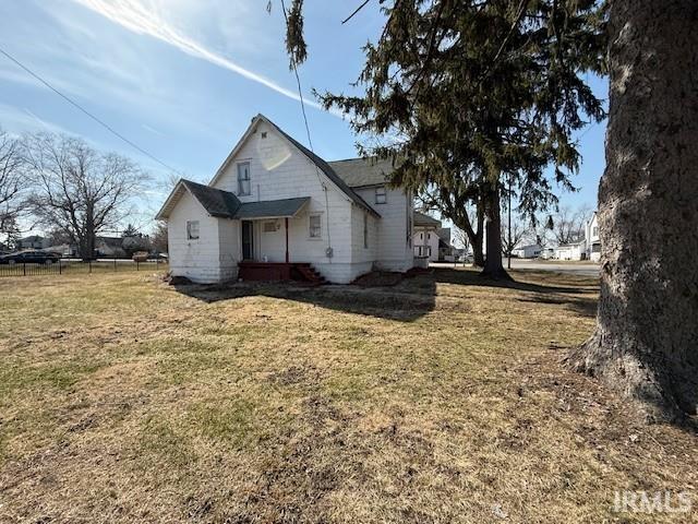 view of side of property with a lawn