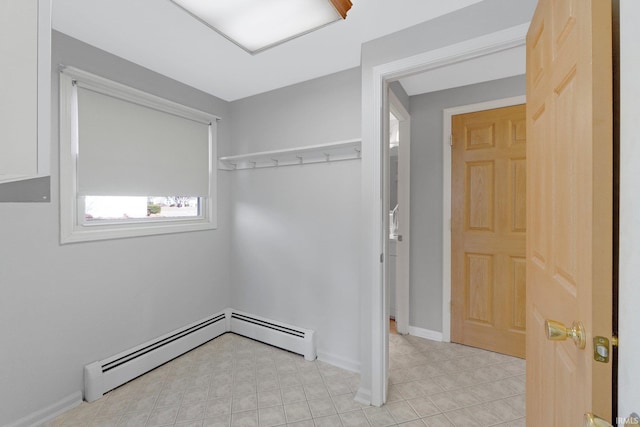 interior space with a baseboard heating unit and baseboards