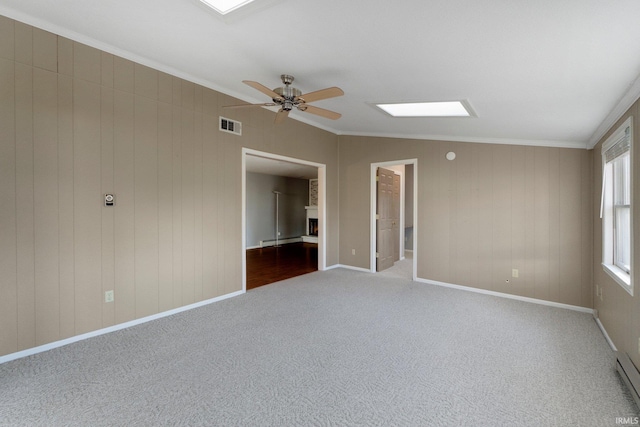 empty room with visible vents, a ceiling fan, ornamental molding, and carpet flooring