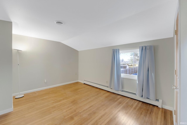 bonus room with visible vents, baseboards, light wood finished floors, a baseboard radiator, and lofted ceiling