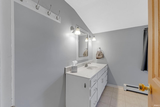 bathroom with tile patterned floors, lofted ceiling, a baseboard heating unit, baseboards, and vanity