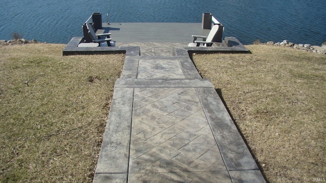 dock area with a yard and a water view