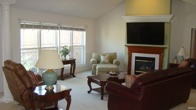 carpeted living room with a fireplace, lofted ceiling, and decorative columns