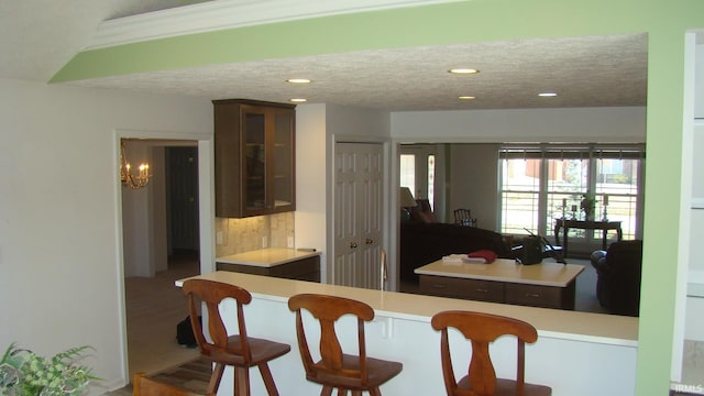 dining room with a textured ceiling, recessed lighting, and a chandelier