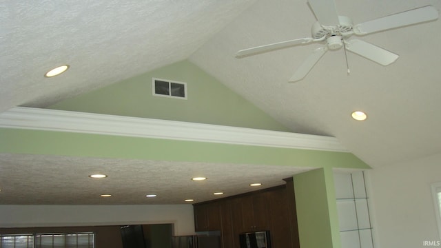 room details with fridge, visible vents, a textured ceiling, and ceiling fan