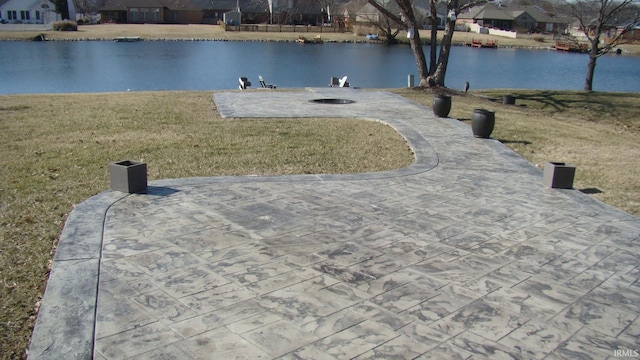 exterior space featuring a water view, a lawn, and a patio